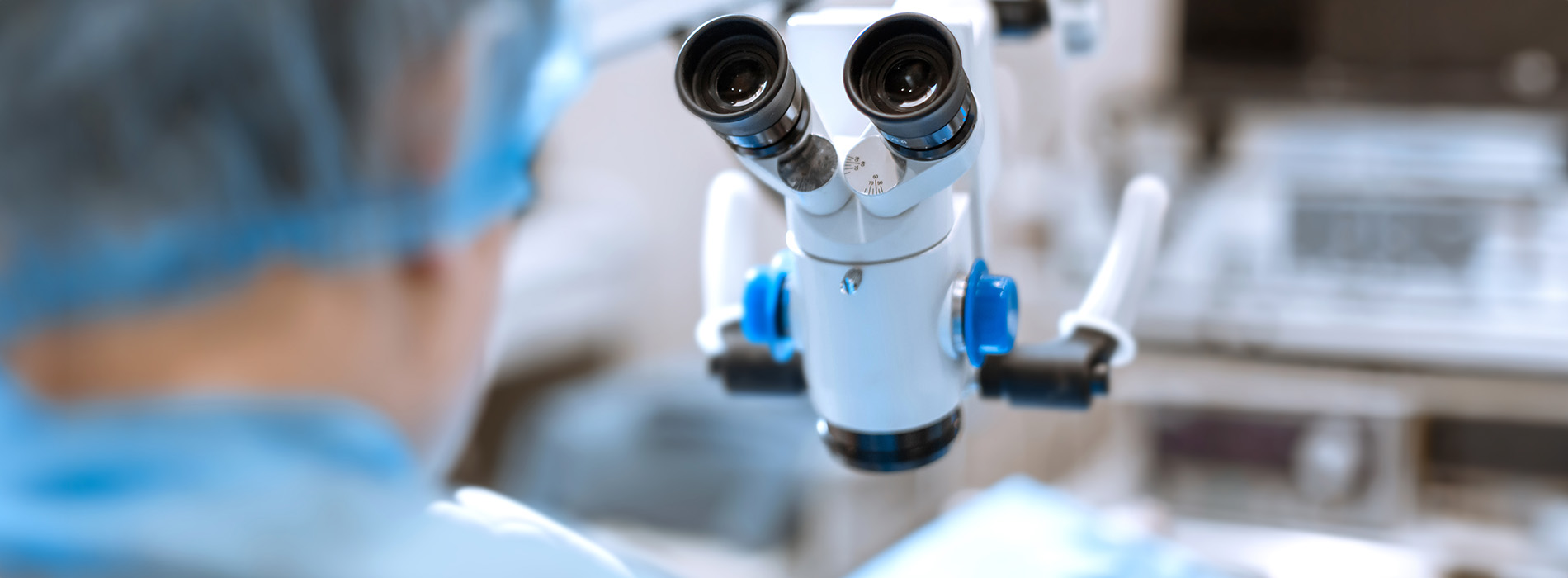 The image shows a medical professional observing through an ophthalmoscope, with a focus on the device and the person s hands holding it.