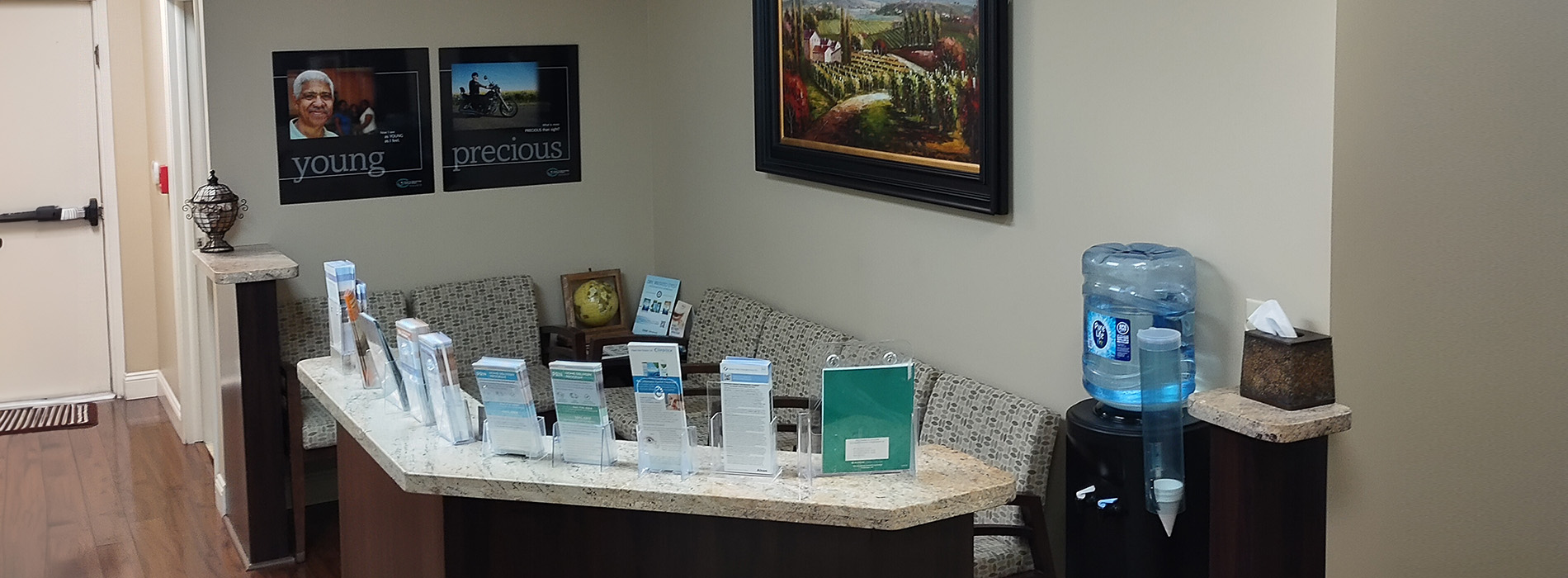 The image shows an interior space with a countertop displaying various items, possibly for sale or use, and framed pictures hanging on the wall above the counter.